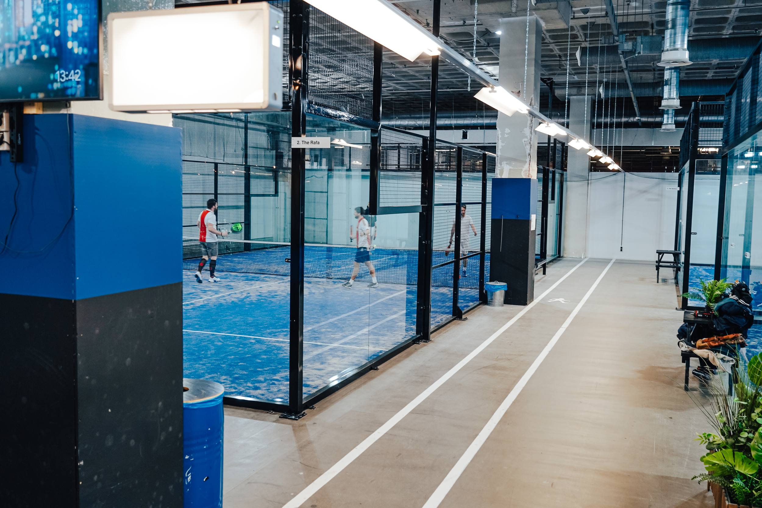 Padelhal met meerdere banen achter glas
